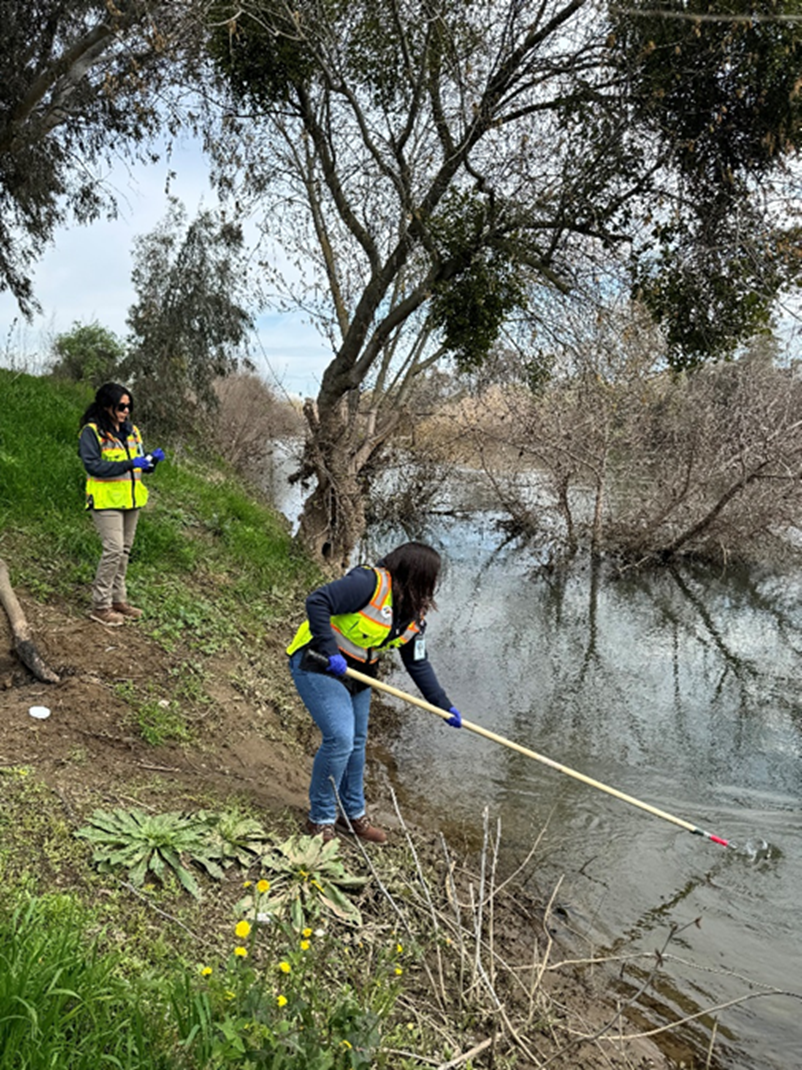 Environmental Compliance Services taking a storm water sample. 